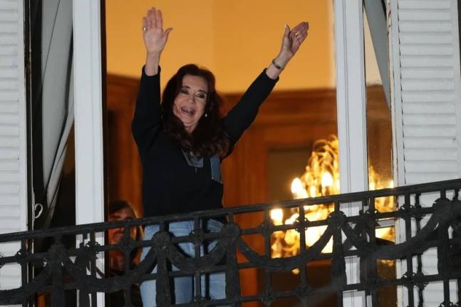 Former Argentine President Cristina Fernandez, who is serving a prison sentence under house arrest for corruption, waves from the balcony of her home during a rally in Buenos Aires, Argentina, September 1.