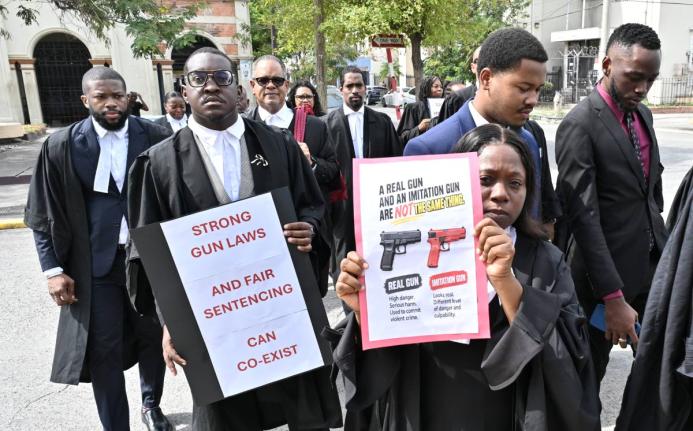 Tamika Harris (right), president of the Advocates’ Association of Jamaica, and other attorneys engage in a silent protest involving members of The Jamaican Bar Association and the Advocates’ Association  at the Supreme Court in downtown Kingston yester