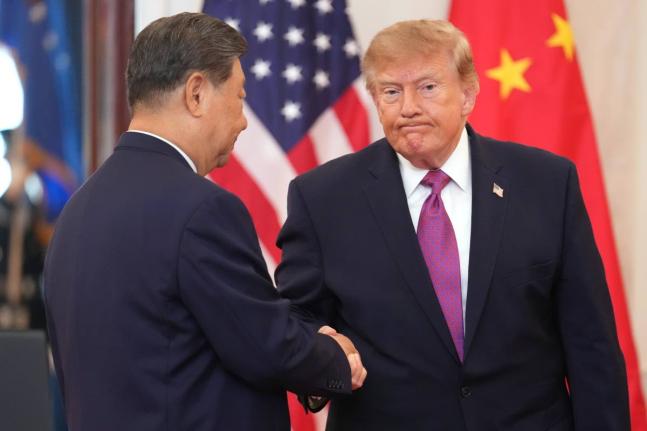 President Donald Trump shakes hands with China’s President Xi Jinping during an arrival ceremony in the Grand Foyer of the White House, Thursday.
