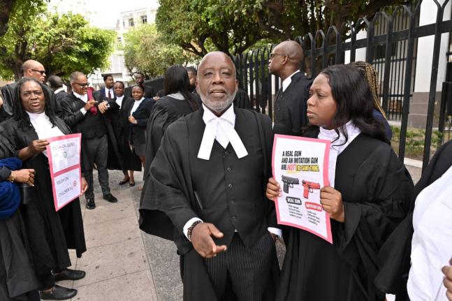 Christopher Townsend (second right), Tamika Harris (right), President of Advocates’ Association of Jamaica along with several attorneys-at-law staged a silent protest on Wednesday at the Supreme Court in Kingston. Organised by the Jamaican Bar Associatio
