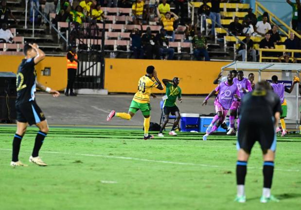 Renaldo Cephas (centre) of Jamaica celebrates after scoring the winner in the Jamaica versus  Guatemala Concacaf Nations League match at the National Stadium last night.