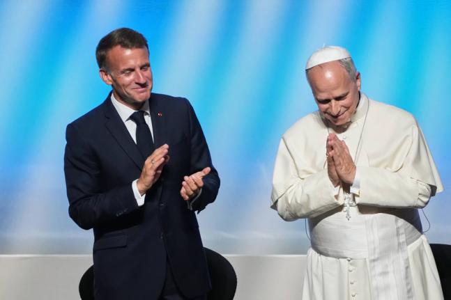 Pope Leo XIV is congratulated by French President Emmanuel Macron (left) after his speech at the ‘At the Roots of Europe for Peace and Unity’ meeting in Metz, France, on Monday.