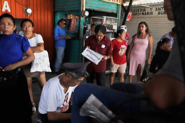 A person reads a newspaper at a market in Campeche, Mexico, on September 17.